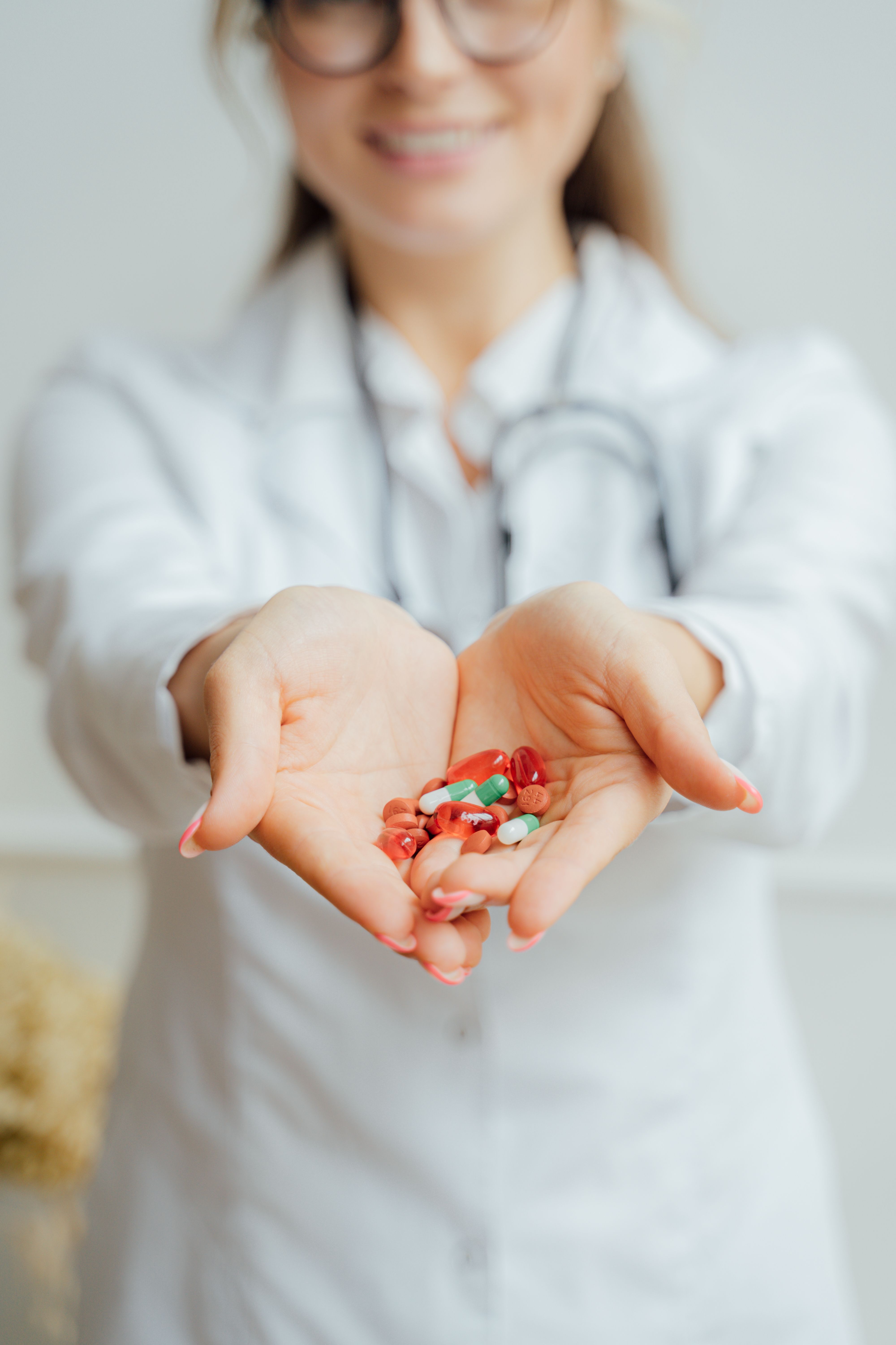 Pharmacist holding a handful of medicine in her open palms